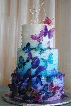 a multi layer cake with butterflies on it