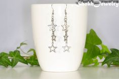 These stunning earrings are made with dangling stainless steel star charms and curb chain. They will remind you to always chase your dreams and look up at the stars at night! These unique and stylish earrings are sure to get you compliments and they would be a wonderful addition to your jewelry collection.The earrings have flat, silver tone fish hook ear wires, and clear plastic backs to keep them in place. The ear hooks are made of Nickel Free metal. You can upgrade your ear wires to hypoallerg Stainless Steel Star Charm Earrings For Gift, Stainless Steel Star Charm Earrings Gift, Star-shaped Metal Earrings With Dangling Charms, Look Up At The Stars, Earrings Cool, Pride Bracelet, Celestial Earrings, Best Mothers Day Gifts, Stylish Earrings