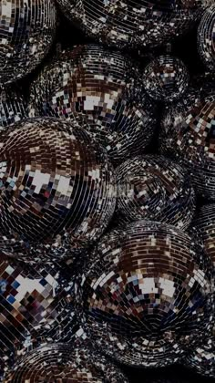 many shiny disco balls are stacked together