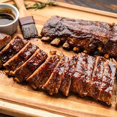 sliced ribs on a cutting board with sauce