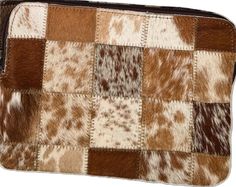 a brown and white cow print purse