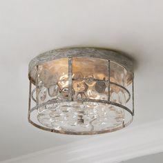 a light fixture in a room with white walls