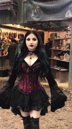 a woman in a corset and boots posing for the camera