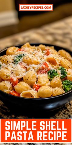 a bowl filled with pasta and broccoli sitting on top of a table next to a