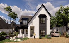 a white and black house with a car parked in the driveway