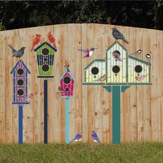 a wooden fence with bird houses painted on it