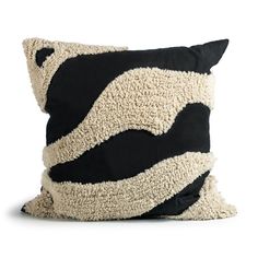 a black and white pillow on a white background