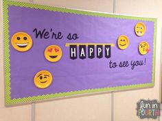 a bulletin board decorated with smiley faces and the words we're so happy to see you