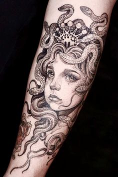 a woman's arm with an octopus and snake tattoo on the left side of her body