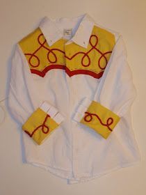 a white shirt with yellow and red designs on the collar is laying on a table