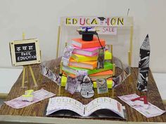 a table topped with lots of books on top of a wooden table next to a sign