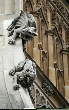 two gargoyles on the side of a building