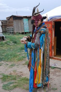 a man dressed up in costume standing outside