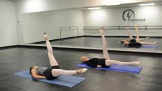 three women doing yoga poses in an empty gym