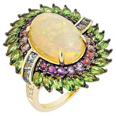 Glamorous Gemstones - Sunita Nahata started off her career as a gemstone trader, and this particular collection reflects her love for multi-colored semi-precious gemstones. The pieces in this collection are exclusively curated by Sunita to present unique items that incorporate fancy and exclusive gemstones cuts and color combinations. Opal Fancy Ring in 18Karat Yellow Gold with Tsavorite, Amethyst, Pink Tourmaline, Aquamarine, and White Diamond. Opal: 4.80 carat, 14X10mm size, oval shape. Tsavorite: 1.96 carat, 4X2mm size, marquise shape. Amethyst: 0.12 carat, 2.00mm size, round shape. Amethyst: 0.06 carat, 2.00mm size, round shape. Amethyst: 0.13 carat, 2.00mm size, round shape. Pink Tourmaline: 0.14 carat, 2.00mm size, round shape. Pink Tourmaline: 0.12 carat, 2.00mm size, round shape. A Fancy Rings, Unique Items, Opal Jewelry, Precious Gemstones, Pink Tourmaline, Cut And Color, Semi Precious Gemstones, White Diamond, Oval Shape