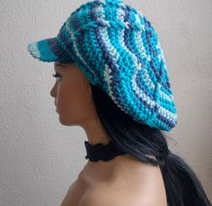 a mannequin head wearing a blue and white crochet knitted hat