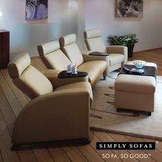 a living room filled with furniture and a flat screen tv sitting on top of a hard wood floor