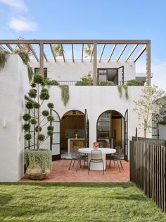 an outdoor dining area with table and chairs