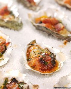 several open oysters sitting on top of an ice covered table