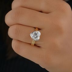 a woman's hand with a diamond ring on it