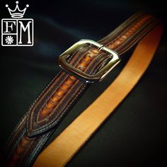 "This Sunburst leather belt starts is 1-3/4\" wide and lined and stitched! It is hand tooled with a unique border pattern made using modified leather stamps, resulting in a highly textured unique design! It is dyed a custom sunburst and the edges are beveled,slicked smooth and finally I hand rub the belt with special waxes and achieve a beautiful vintage finish. The unique centerbar buckle closes it up and it can be worn with your own buckle as the belt uses 2 snaps to attach. I need your waist Custom Engraved Leather Belt Buckles, Custom Brown Engraved Belts, Custom Engraved Brown Belts, Guitar Straps, Handmade Belts, Leather Stamps, Belt Brown, Cuff Watch, Border Pattern