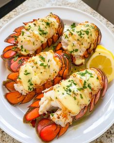 lobsters with lemon and parsley on a white plate