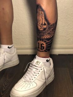 a person with a tattoo on their leg and white nike air force sneakers in front of them