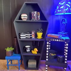 a blue shelf with various items on it and a lamp in the corner next to it