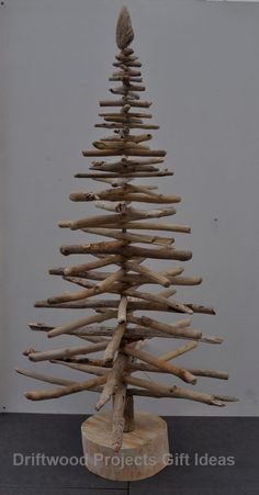 a wooden christmas tree made out of driftwood