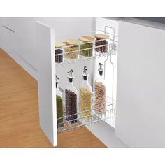 an organized spice rack in the corner of a kitchen