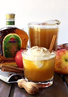 an apple cider cocktail with cinnamon and whipped cream