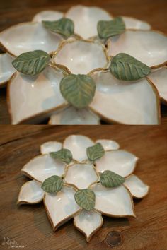 two white dishes with green leaves on them