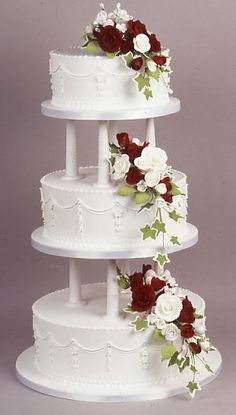 three tiered wedding cake with red and white flowers