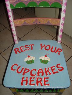 a wooden chair with cupcakes on it that says rest your cupcakes here