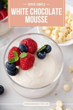 white chocolate mousse with raspberries and blueberries in a glass bowl