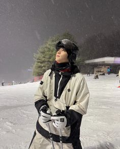 a person standing in the snow with skis on