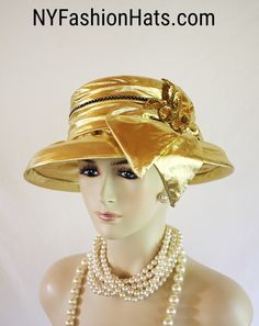 "Women's Metallic Gold And Black Custom Made Couture Lame Fabric Formal Designer Fashion Hat. This Elegant Dress Hat Is Embellished With A Large Bow And A Large Sequin Applique. A Row Of Clear Acrylic Black Encased Rhinestones Encircle The Upper Portion Of The Crown Crown Measures 22.5\". Standard Sized Fits Most Women Condition Is New Custom Made This Formal Luxury Hat Is Suited For Weddings, Formals, Church, Shabbat, Mother Of The Bride Or Groom, Formal Special Occasion Events And Winter Holid Lame Fabric, Luxury Hats, Large Sequins, Hat Wedding, Bridal Hat, Gold Hats, Wedding Church, Gold Lame, Sequin Appliques