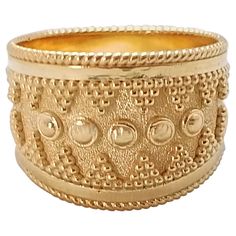 This S.Georgios designer wide band ring is made from solid 18 Karat Yellow Gold and is microscopically decorated with handmade granulation work to create a stunning and elegant art piece. We have finished this beautiful band with a stunning unique velvet background to accentuate the Byzantine style beadwork design. We also make this gorgeous band ring in White and Rose Gold, please contact us. All Georgios Collections jewelry is handmade in our workshop in Athens Greece and is of outstanding qua Velvet Background, Byzantine Jewelry, Byzantine Necklace, Indian Rings, Microscopes, Wide Band Ring, Elegant Art, Wide Band Rings, Domed Ring