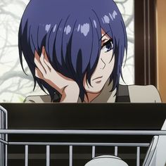 an anime character with blue hair sitting in front of a laptop