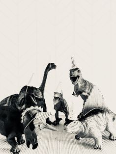 three dinosaurs wearing party hats are playing with each other on the floor in black and white