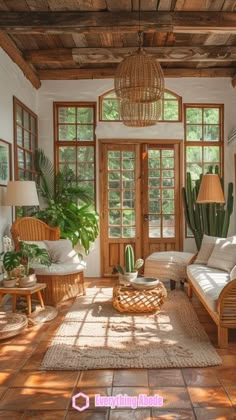 a living room filled with lots of furniture and plants on top of wooden flooring