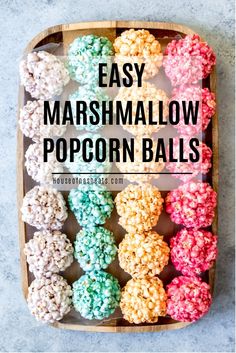 easy marshmallow popcorn balls in a wooden tray