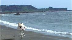 a cartoon character is walking on the beach