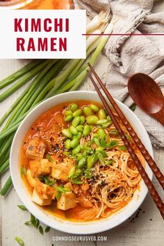 a bowl of kimchi ramen with chopsticks next to it