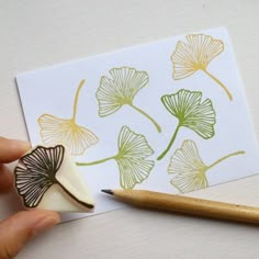 a rubber stamp sitting on top of a piece of paper next to a wooden pencil