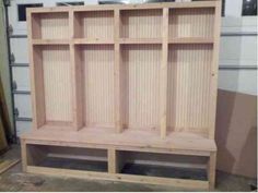 an unfinished wooden shelf with the words lockers on it