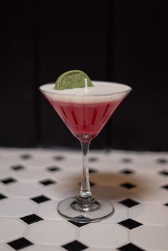 a small martini with a lime garnish on the rim