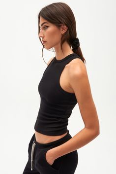 A high racer front and back neckline add a bit of sophistication to our classic tank. Super soft baby rib fabric to hug your body and layer effortlessly. BEST FOR: running, yoga, CrossFit, barre, Pilates, spin class and gym workouts. Model is 5'10" and wears a size small. NEW LONGER LENGTH Versatile Black Tank Top For Yoga, Black Seamless Tank Top For Pilates, Black Ribbed Racerback Tank Top, Black Fitted Tank Top For Yoga, High Neck Stretch Yoga Tops, Fitted Black Tank Top For Yoga, High Neck Stretch Tops For Yoga, Stretch High Neck Yoga Tops, Stretch High Neck Tops For Yoga