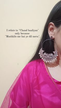 a woman in a pink sari with large earrings on her ear and an inspirational quote