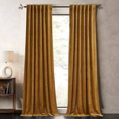 a room with a large window that has yellow curtains hanging on the side of it